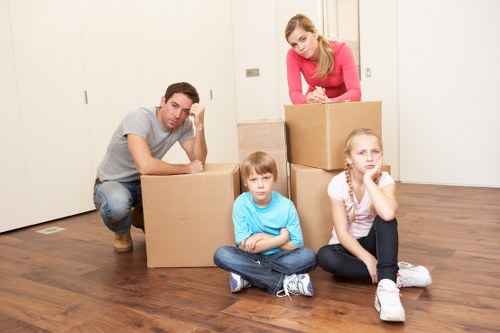 Professional movers handling furniture in a Catford property